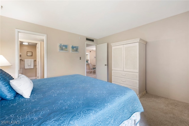 carpeted bedroom featuring visible vents