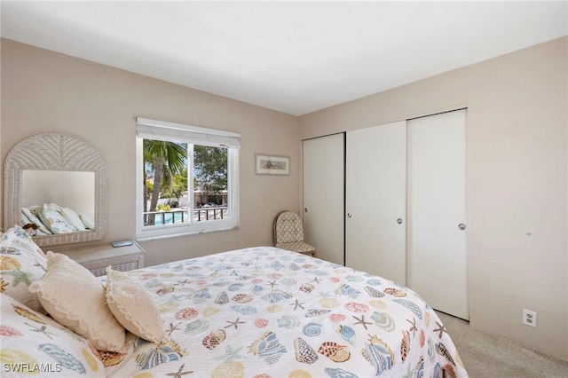 bedroom featuring a closet and light colored carpet