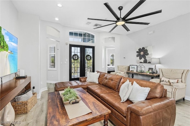 living room featuring ceiling fan and hardwood / wood-style floors