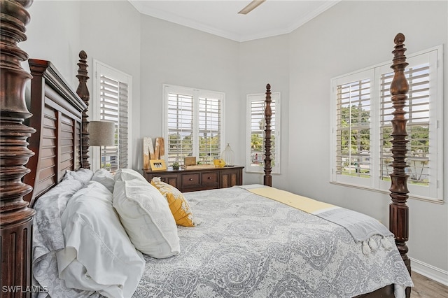 bedroom with ceiling fan, wood-type flooring, and crown molding