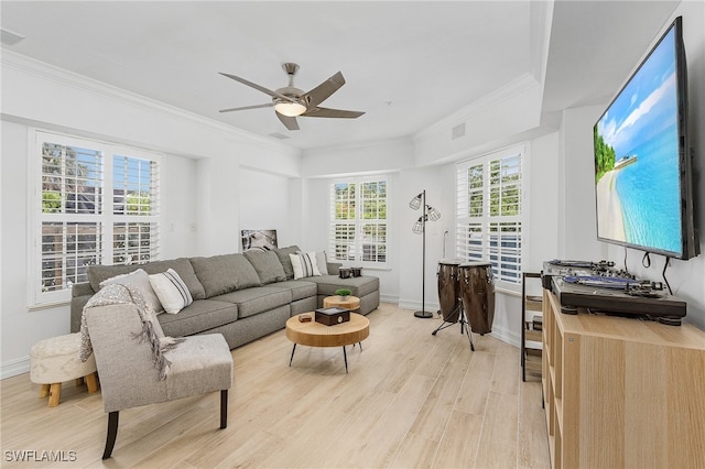 living room with light hardwood / wood-style floors, ceiling fan, and crown molding