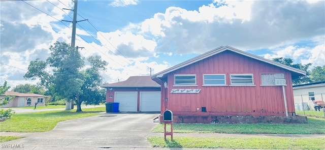 view of side of home with a garage and a yard