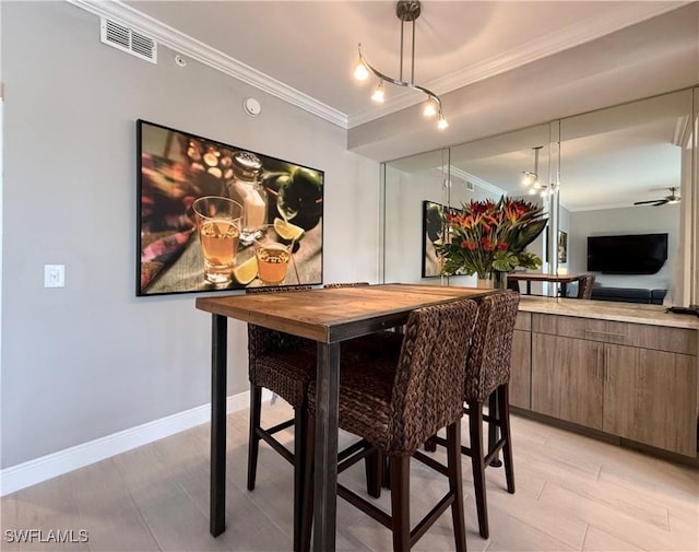 7505 Stoneybrook Dr Unit 716, Naples, FL 34112 - dining area with crown molding, a ceiling fan, light wood-type flooring, and baseboards