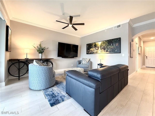 living room featuring light hardwood / wood-style flooring, ceiling fan, and crown molding