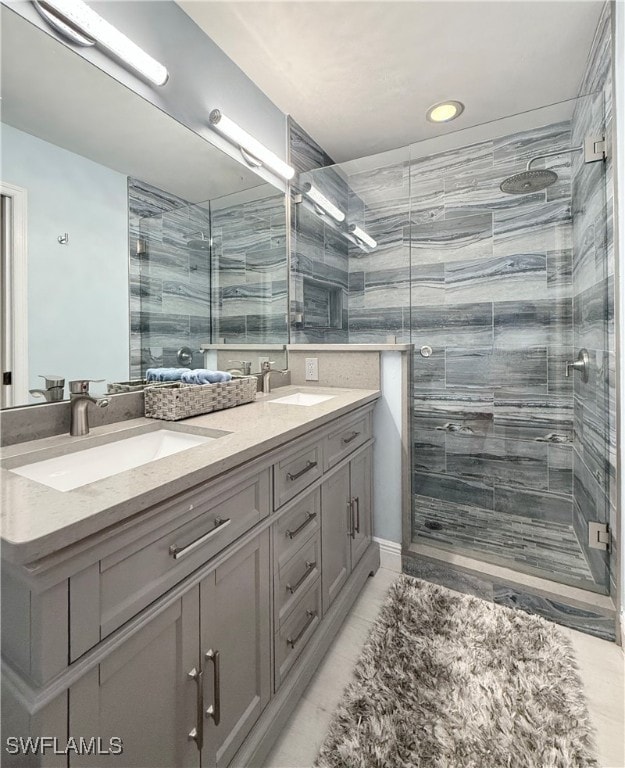 bathroom with walk in shower and vanity