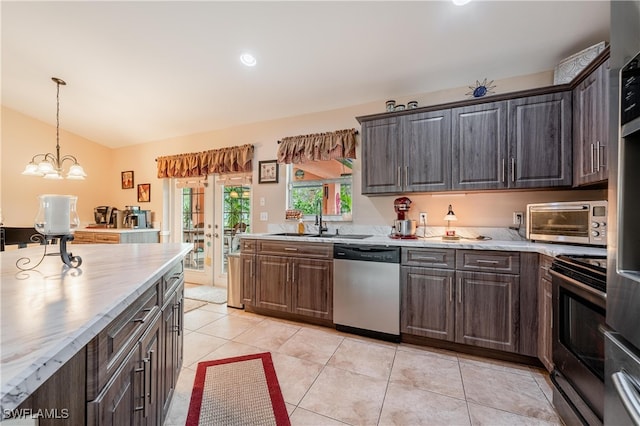 kitchen featuring dark brown cabinetry, sink, stainless steel appliances, a notable chandelier, and light tile patterned floors