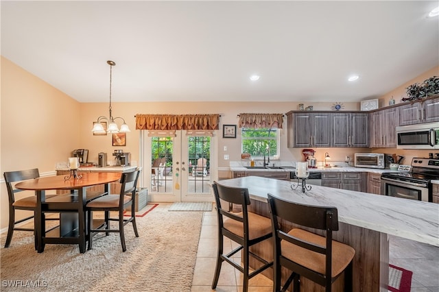 kitchen featuring french doors, sink, a notable chandelier, dark brown cabinetry, and stainless steel appliances