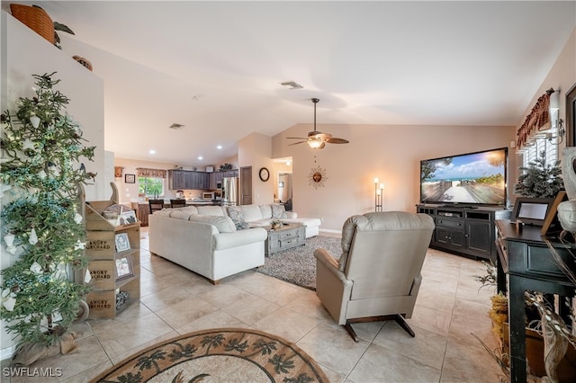 tiled living room with ceiling fan and vaulted ceiling