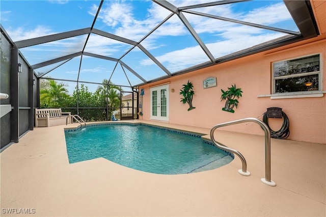 view of swimming pool with glass enclosure, french doors, and a patio