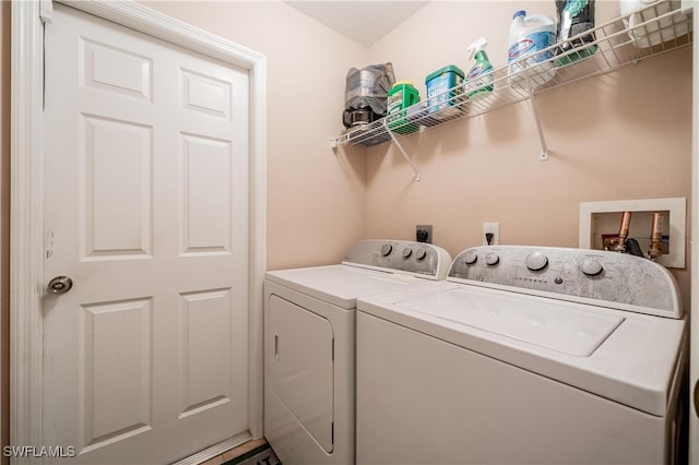 clothes washing area featuring separate washer and dryer