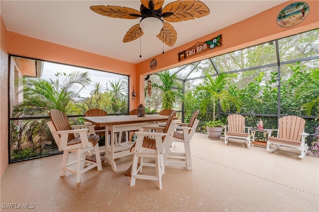 sunroom / solarium featuring plenty of natural light and ceiling fan