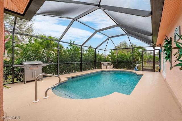 view of swimming pool featuring a patio area, glass enclosure, and grilling area