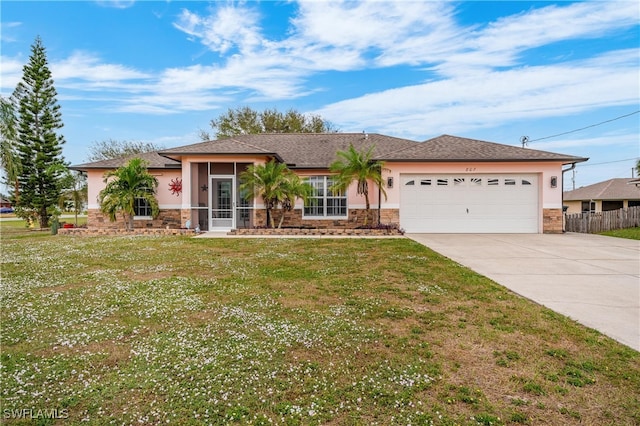 single story home with a garage, a front lawn, and a sunroom