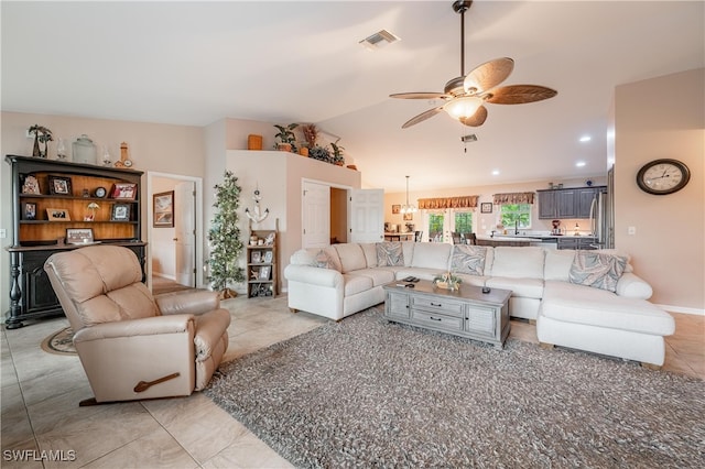 tiled living room with ceiling fan and lofted ceiling