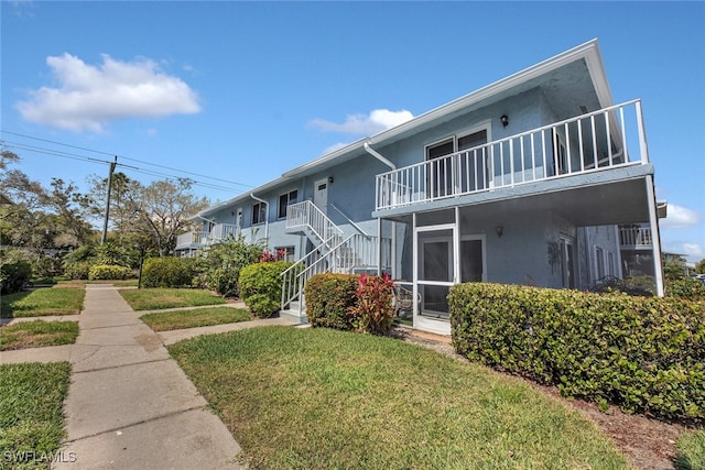 exterior space with a yard and a balcony