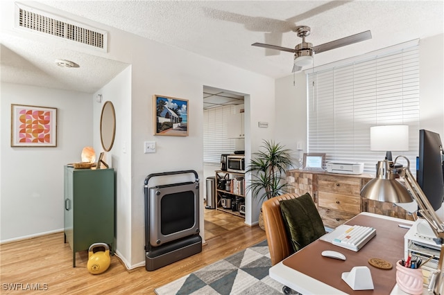 office featuring hardwood / wood-style floors, a textured ceiling, and ceiling fan