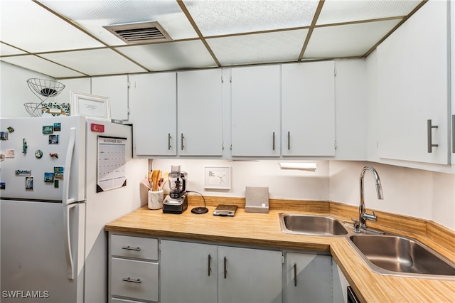 kitchen featuring white refrigerator and sink