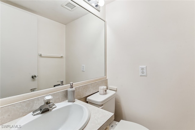 bathroom with toilet and vanity