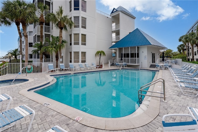 view of swimming pool with a community hot tub and a patio