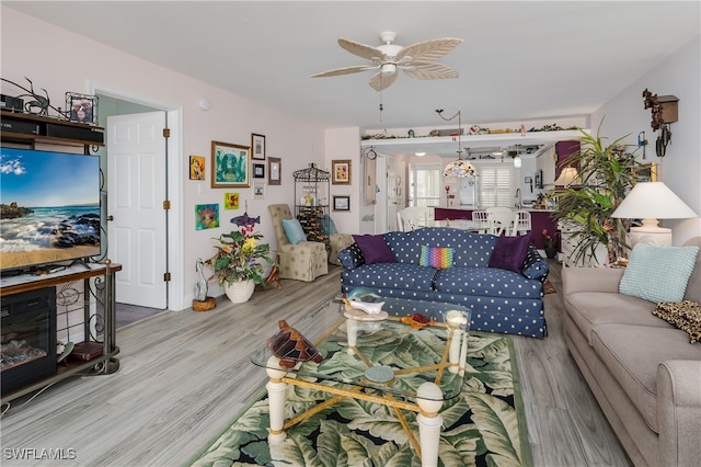 living room with wood-type flooring and ceiling fan