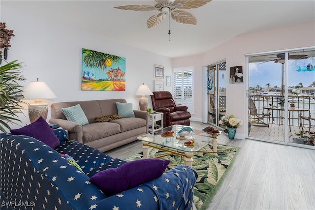 living room with ceiling fan, wood-type flooring, and a healthy amount of sunlight