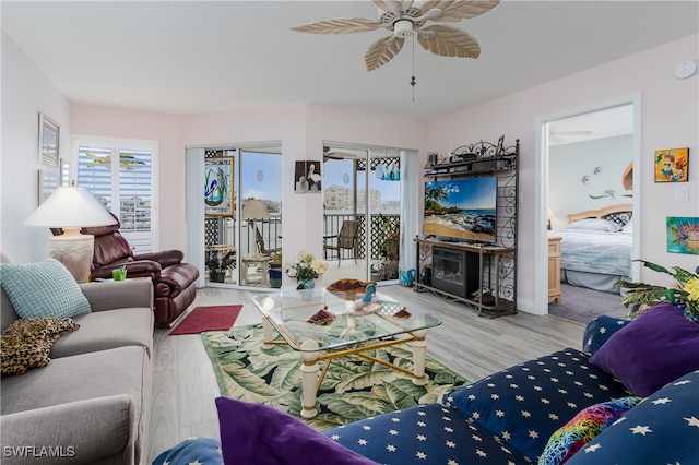 living room featuring light hardwood / wood-style flooring and ceiling fan