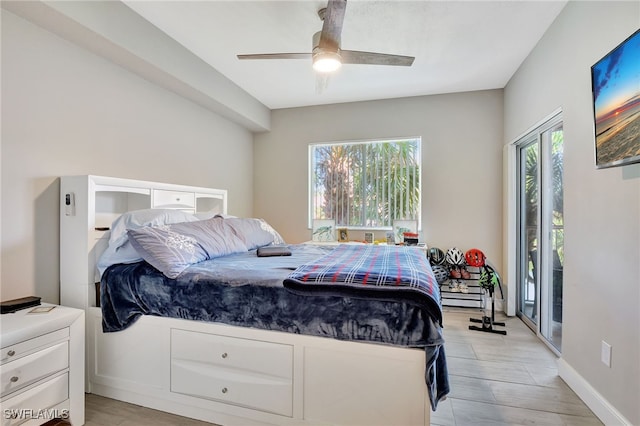 bedroom with multiple windows, light wood-type flooring, a ceiling fan, and baseboards