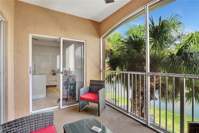 sunroom / solarium with a water view