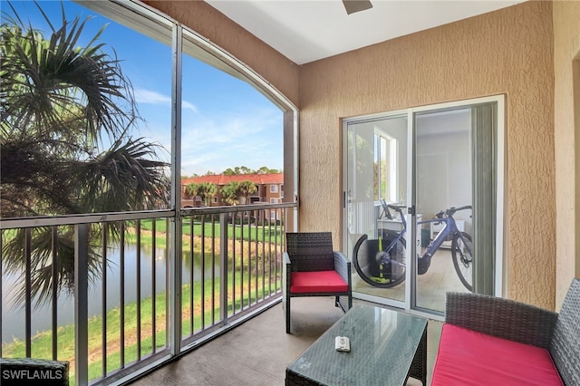 balcony with a water view and a sunroom