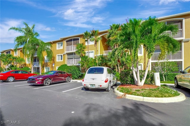 view of property featuring uncovered parking