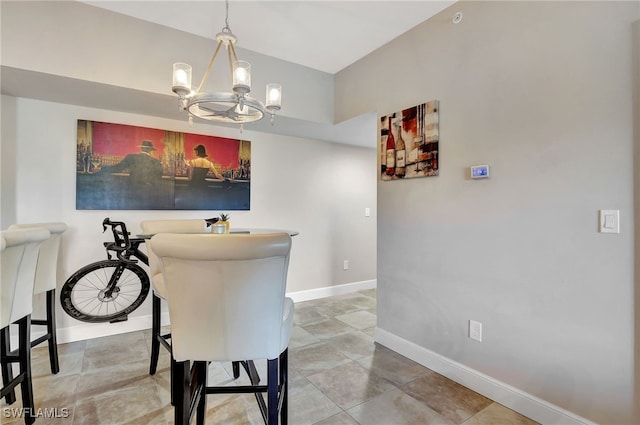 dining room with a notable chandelier and baseboards