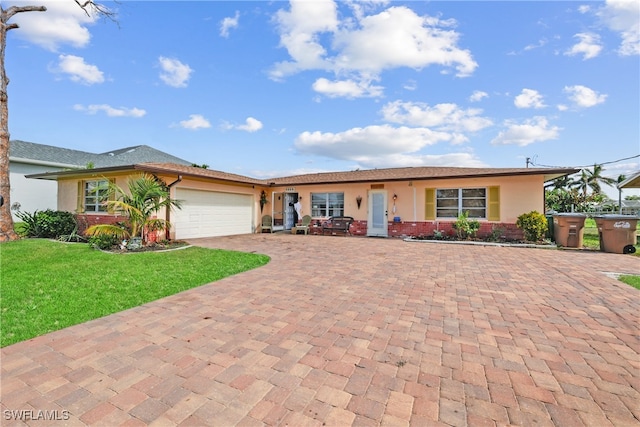 single story home with a front lawn and a garage