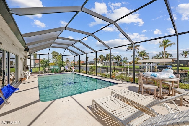 view of pool featuring a patio and glass enclosure