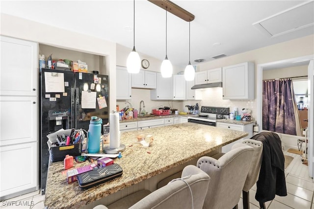 kitchen with black appliances, light stone counters, white cabinetry, and sink