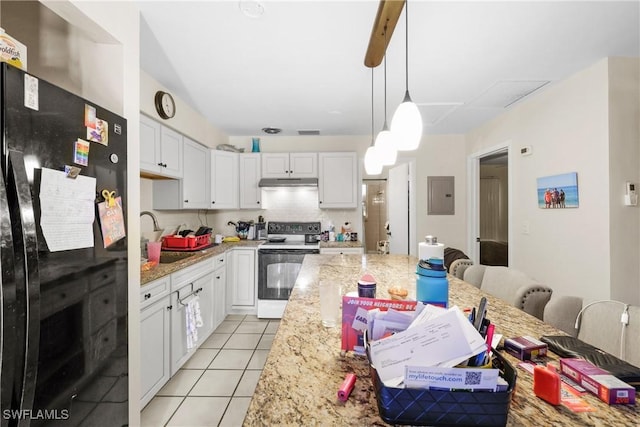 kitchen featuring white electric range oven, pendant lighting, black fridge, and white cabinetry