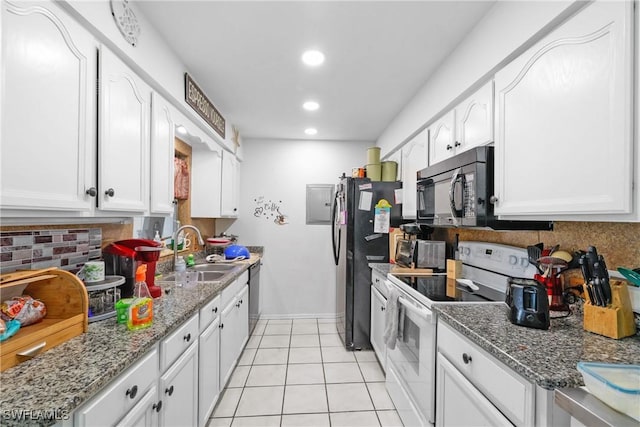 kitchen with decorative backsplash, sink, white cabinets, and white stove