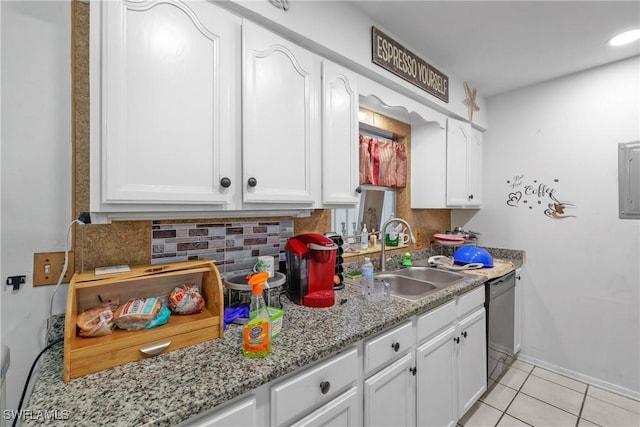 kitchen with light stone countertops, backsplash, sink, black dishwasher, and white cabinetry