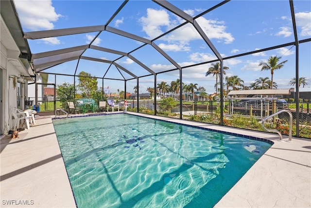 view of swimming pool featuring glass enclosure and a patio area