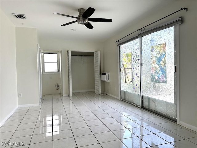 unfurnished bedroom with multiple windows, ceiling fan, and light tile patterned floors