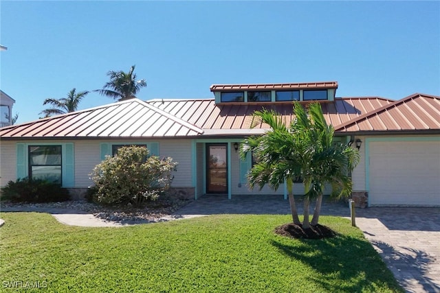 view of front of property with a front lawn and a garage