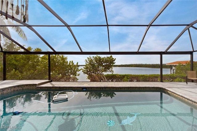 view of pool featuring glass enclosure, a water view, and a patio