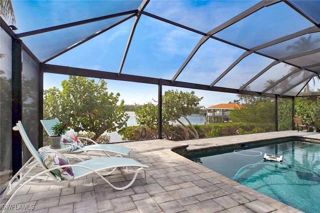 view of pool featuring a lanai, a water view, and a patio