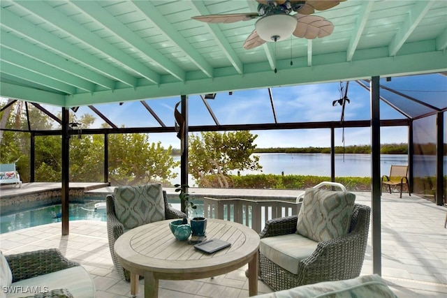 view of patio with glass enclosure, ceiling fan, outdoor lounge area, and a water view