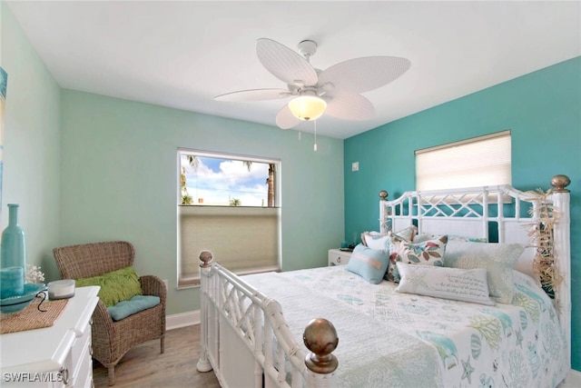 bedroom with ceiling fan, light wood-type flooring, and multiple windows