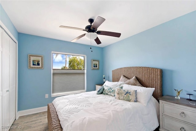 bedroom featuring ceiling fan, light hardwood / wood-style floors, and a closet