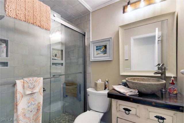 bathroom featuring walk in shower, toilet, vanity, and ornamental molding