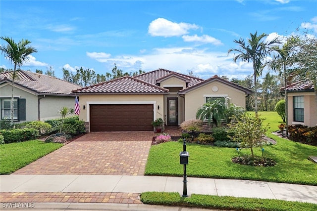 mediterranean / spanish-style house with a front yard and a garage