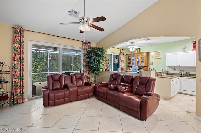 tiled living room with sink, vaulted ceiling, and ceiling fan