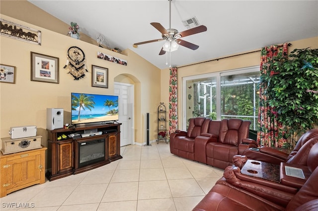 living room featuring ceiling fan, light tile patterned floors, and lofted ceiling