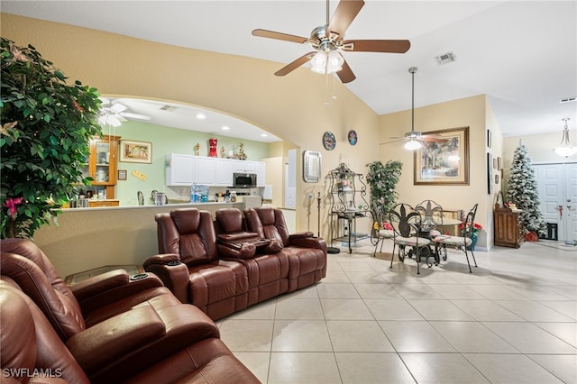 tiled living room featuring high vaulted ceiling and ceiling fan